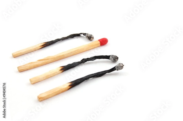 Fototapeta Some red matches isolated on a white background.