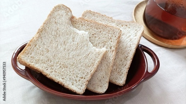 Fototapeta Wholemeal bread in ceramic bowl
