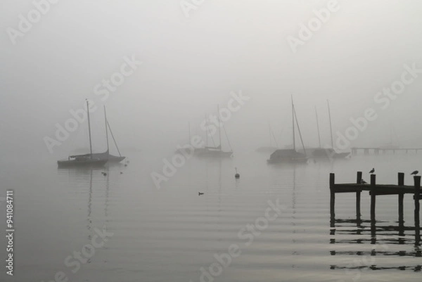 Obraz some sailing boats in the backlight on Lake Ammersee in the morning mist