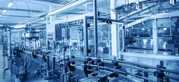 Obraz Modern automated factory assembly line for bottling beverages. Advanced industrial equipment and machinery emphasize efficiency, automation, and high-tech manufacturing processes in sterile