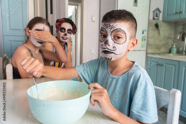 Fototapeta mother and children prepare bread of the dead for the holiday, day of the dead in mexico, halloween, family having fun and baking pies, dough, flour, buns, hands,