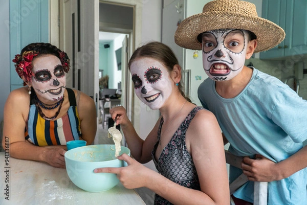 Fototapeta mother and children prepare bread of the dead for the holiday, day of the dead in mexico, halloween, family having fun and baking pies, dough, flour, buns, hands,