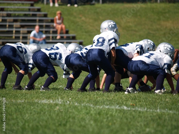Fototapeta a young american football team ready at the line of scrimmage