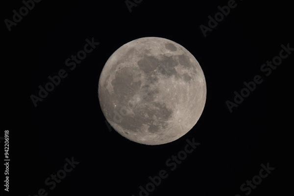 Obraz photograph of the full moon partially covered with clouds