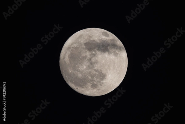 Obraz photograph of the full moon partially covered with clouds