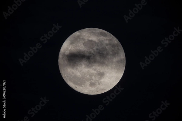 Obraz photograph of the full moon partially covered with clouds