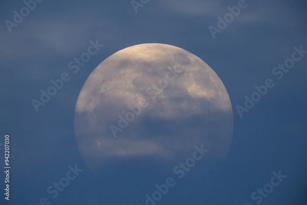 Obraz photograph of the full moon partially covered with clouds