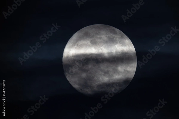 Obraz photograph of the full moon partially covered with clouds