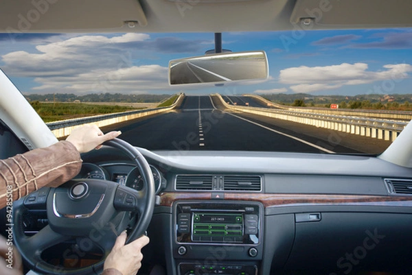 Obraz Close up of hands on a steering wheel.