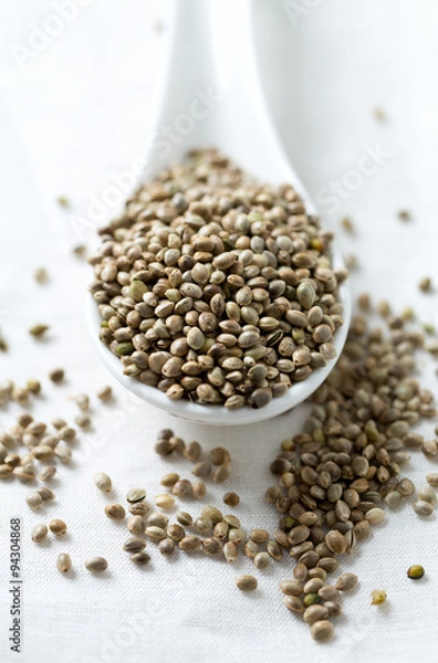 Fototapeta hemp seeds on wooden surface