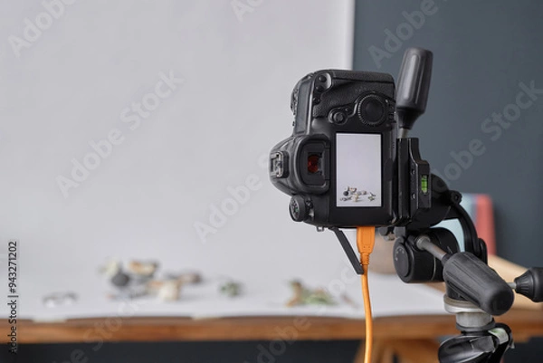 Fototapeta Background image of professional DSLR camera mounted on tripod in photographers studio during commercial product photoshoot copy space