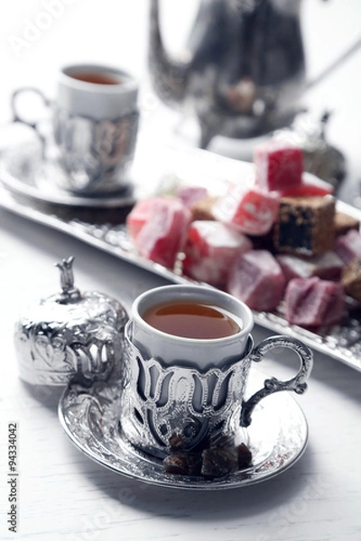 Fototapeta Antique tea-set with Turkish delight on table close-up