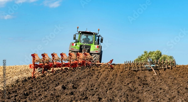 Fototapeta Tractor with 7-share reversible plow and packer cultivating the field after the grain harvest - 2139