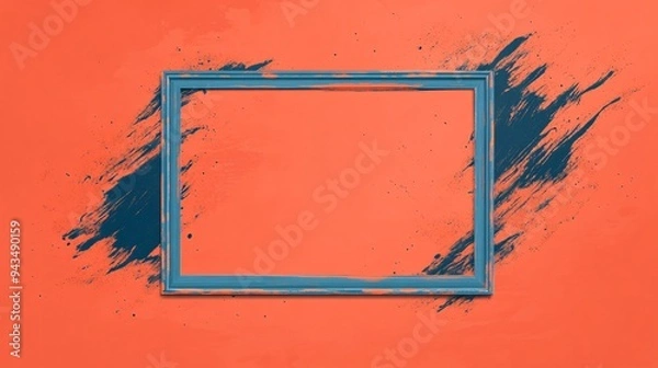 Fototapeta An empty blue frame against a vibrant orange wall with dynamic paint splashes.
