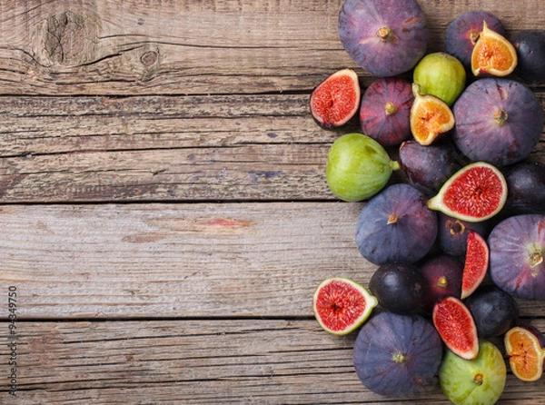 Fototapeta Fresh figs in different grade, vintage wooden Board.Copy space.selective focus