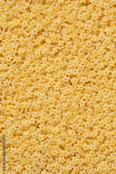 Fototapeta Pasta stelline texture. Dry uncooked italian pasta stelline natural texture or background, close-up, high resolution.