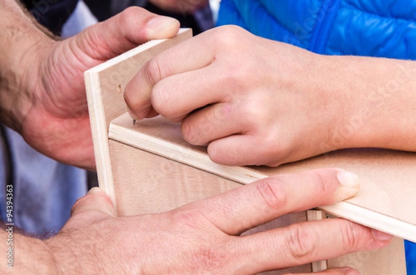 Obraz Hand holding a nail