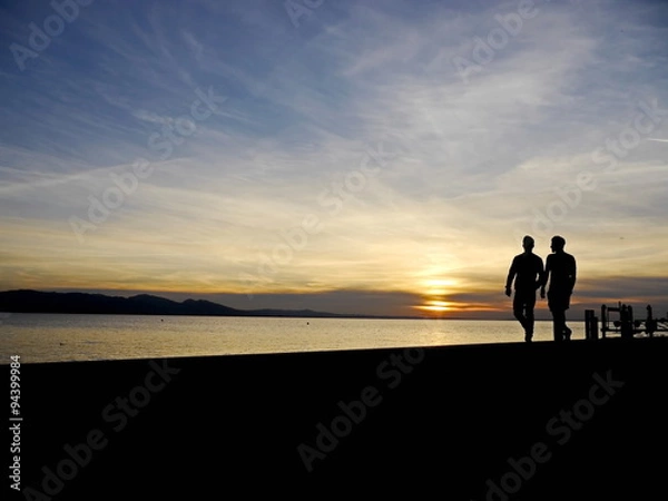 Fototapeta couple walking sunset