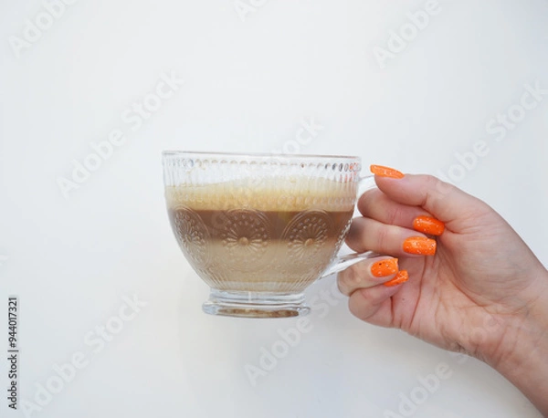 Obraz Cup of coffee in womans hand on white background
