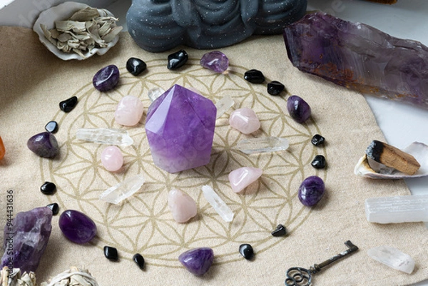 Fototapeta A top view image of several crystals arranged on a sacred geometry grid cloth for the purpose of spiritual healing.
