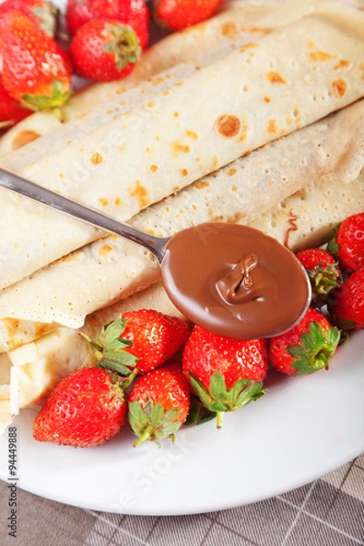 Obraz Pancakes with chocolate and strawberries