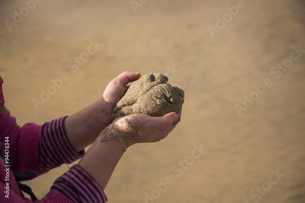 Fototapeta Child holding a sand heart