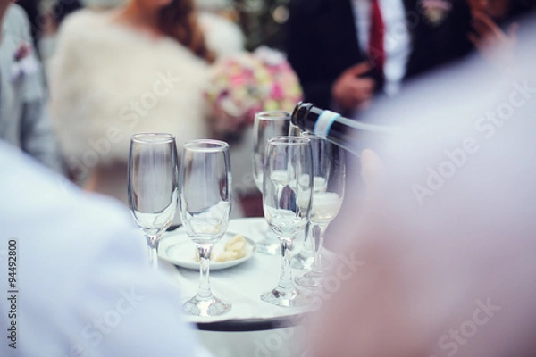 Obraz Waiter pouring champagne in glasses