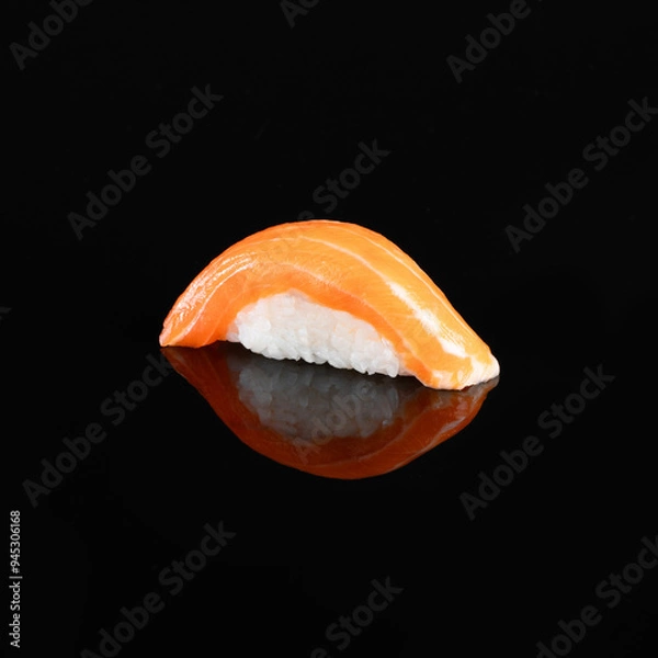 Fototapeta Close-up of a delectable salmon nigiri sushi garnished with a delicate topping, isolated on a dark background