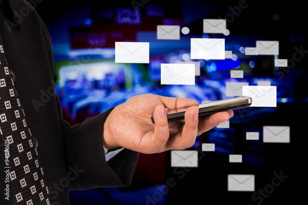 Fototapeta Business woman sending email by using mobile phone.