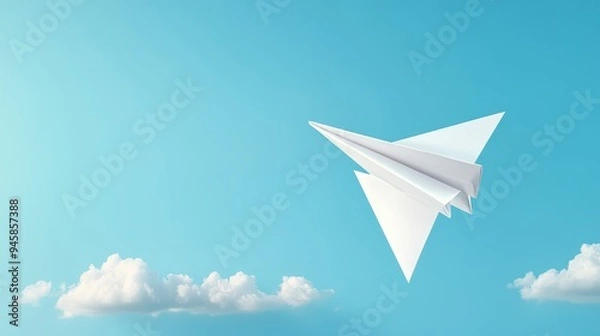 Fototapeta A white paper airplane soars through a clear blue sky, symbolizing freedom, aspirations, hope, dreams, and the pursuit of new horizons.