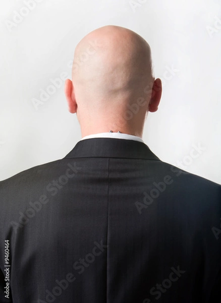 Fototapeta Rear view of bald man wearing suit over white background