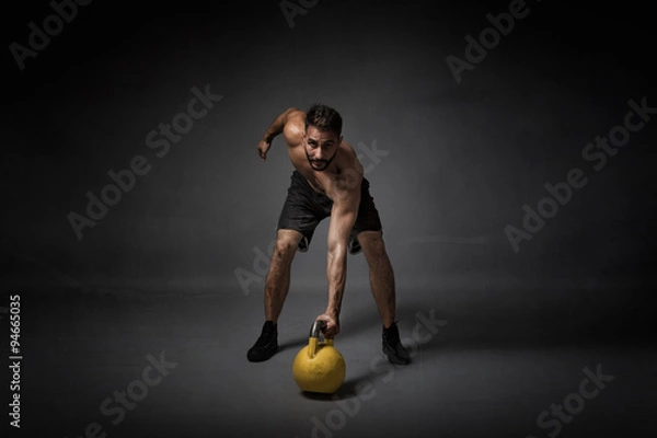 Obraz man with kettleball on hand