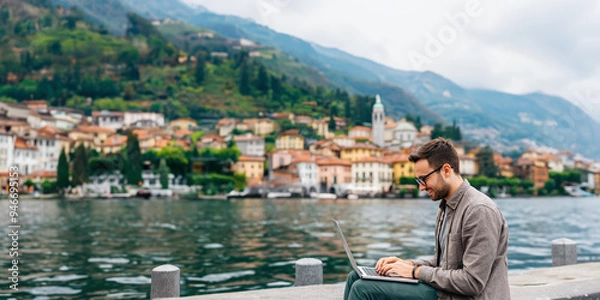 Fototapeta Digital Nomad Working Remotely by a Serene Lake