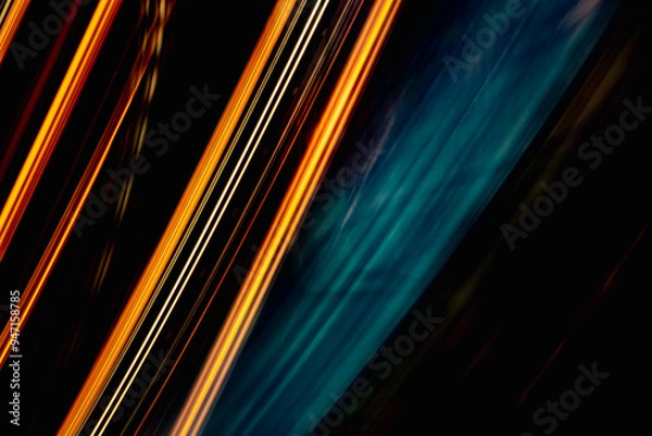 Obraz A blurry image of a black background with orange and blue lines. The image has a dreamy, surreal quality to it