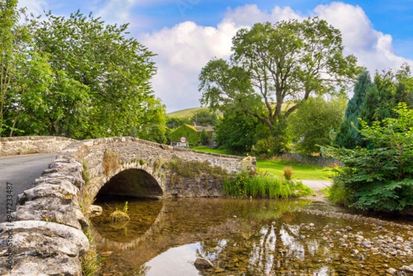 Obraz New Bridge, Malham, North Yorkshire - a humped bridge, originally a packhorse bridge, crossing Malham Beck.
