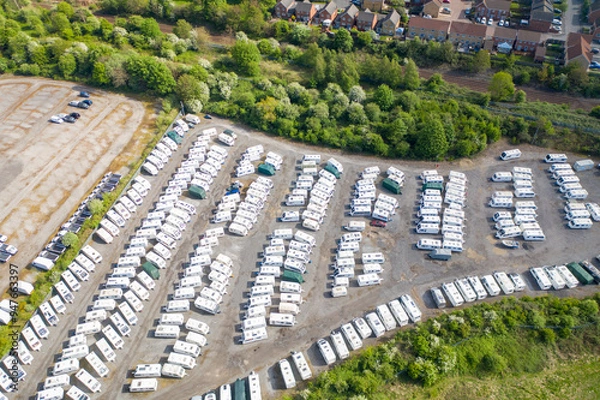 Fototapeta Aerial photo of a caravan storage yard located in the village of Castleford in Wakefield West Yorkshire in the UK showing rows of caravans and motorhomes surrounded by trees