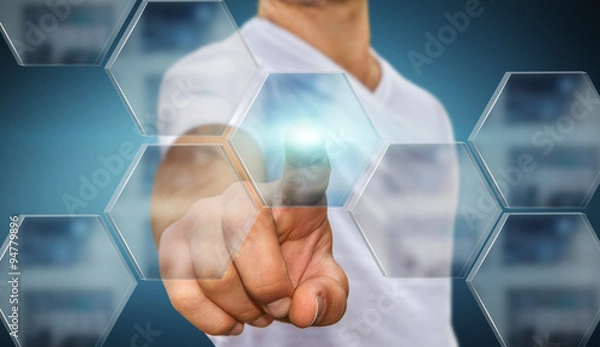 Fototapeta Businessman in his office using tactile interface