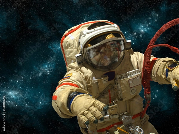 Fototapeta A cosmonaut floats in deep space - Elements of this image furnished by NASA.