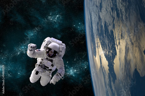Fototapeta An astronaut floats in the zero gravity environment of space - Elements of this image furnished by NASA.