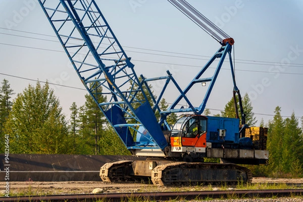 Fototapeta Large blue crane on a construction site