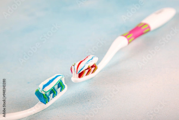 Fototapeta Toothbrush and toothpaste, squeezing toothpaste from tube onto toothbrush close-up. Daily oral care after meals concept.