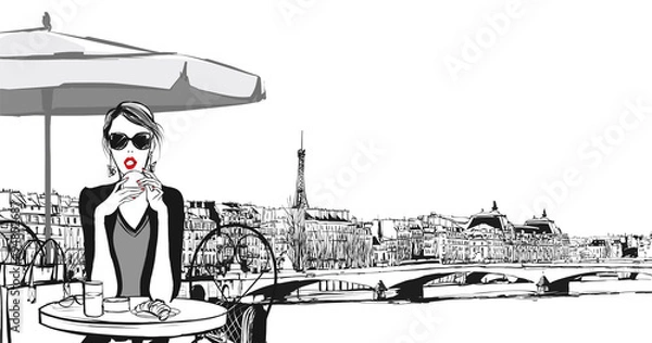 Fototapeta Young woman having breakfast in Paris