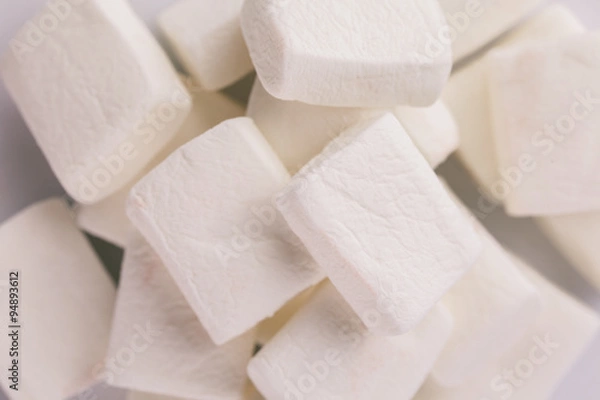 Obraz Pile of original marshmallows in red pastel background.