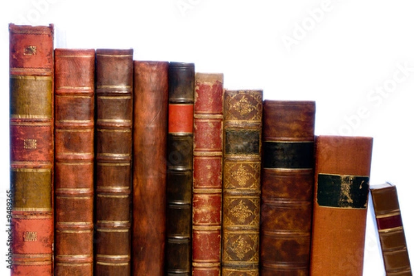 Obraz A row of antique leather books isolated on a white background