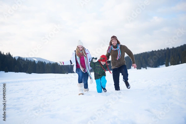 Obraz happy family playing together in snow at winter