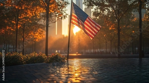 Fototapeta Ground Zero Memorial during sunset with an American flag gently blowing in the wind