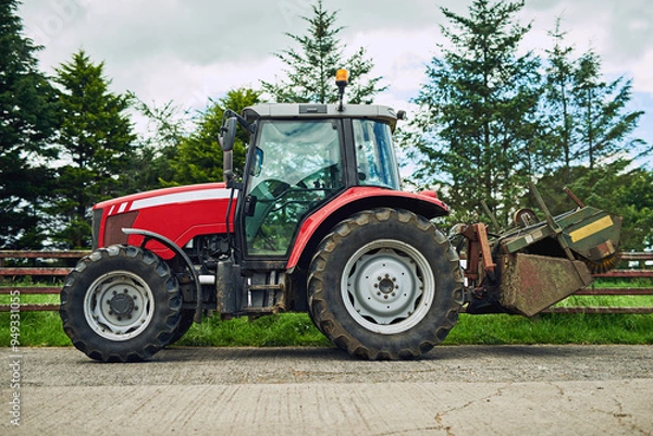 Fototapeta Outdoor, countryside and agriculture with tractor for driving, tiling and cultivation of soil for crop growth. Blue sky, nature and machine truck on farm for harvesting, planting and sowing of seeds