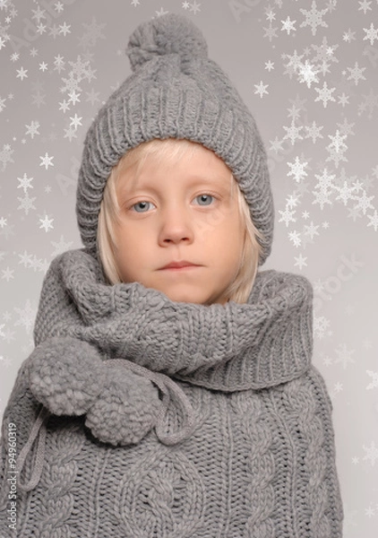 Obraz Boy in winter clothing in the snow flakes