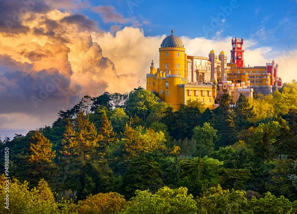Fototapeta Sintra, Portugal. Palace of Pena in the National park. Lisbon. Sunrise among green trees. Beautiful fairytale castle forest pine-trees. Panoramic summer view at palace. Sunlight clouds on sky
