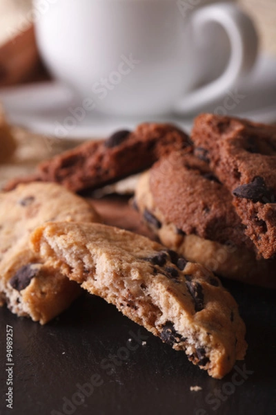 Fototapeta Chocolate chip cookies macro on a background of the cup. Vertical
